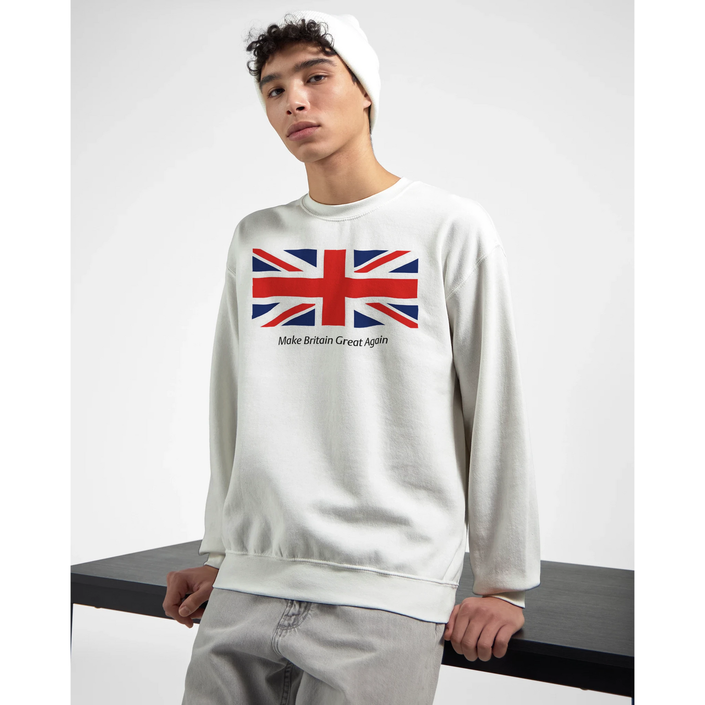 Person wearing a white men's graphic sweatshirt with a Union Jack design and text.