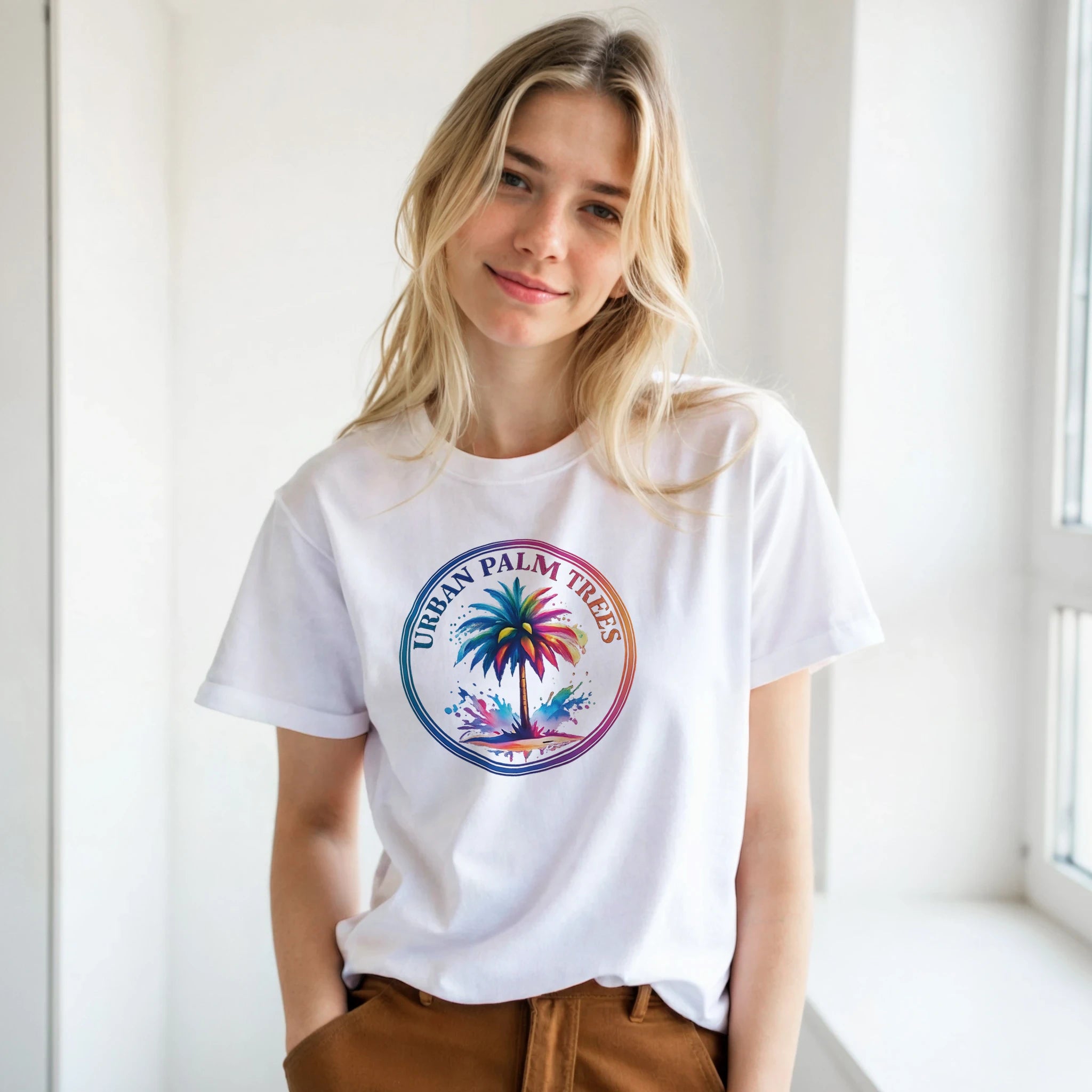 Woman wearing white retro palm tree T-shirt with a colorful circular palm tree graphic.