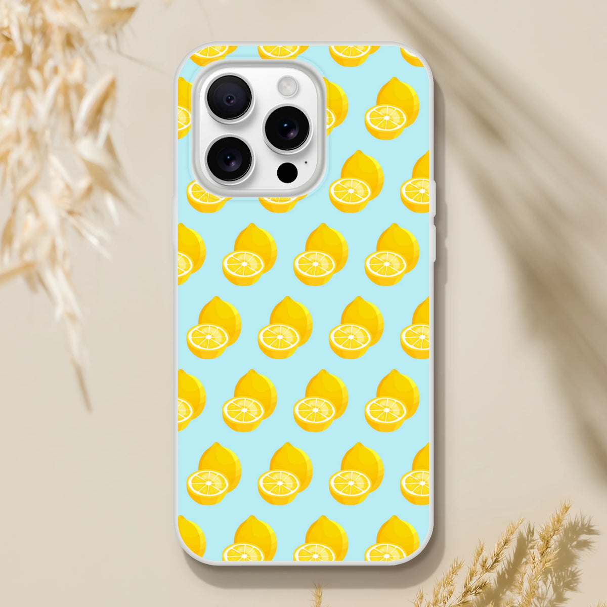 Pastel blue iPhone case featuring a bright yellow repeating lemon pattern. Cute summer fruit design with shock-absorbing TPU protection for daily use.