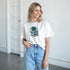 White tropical beach graphic tee for women with palm tree design, soft cotton blend, relaxed fit.