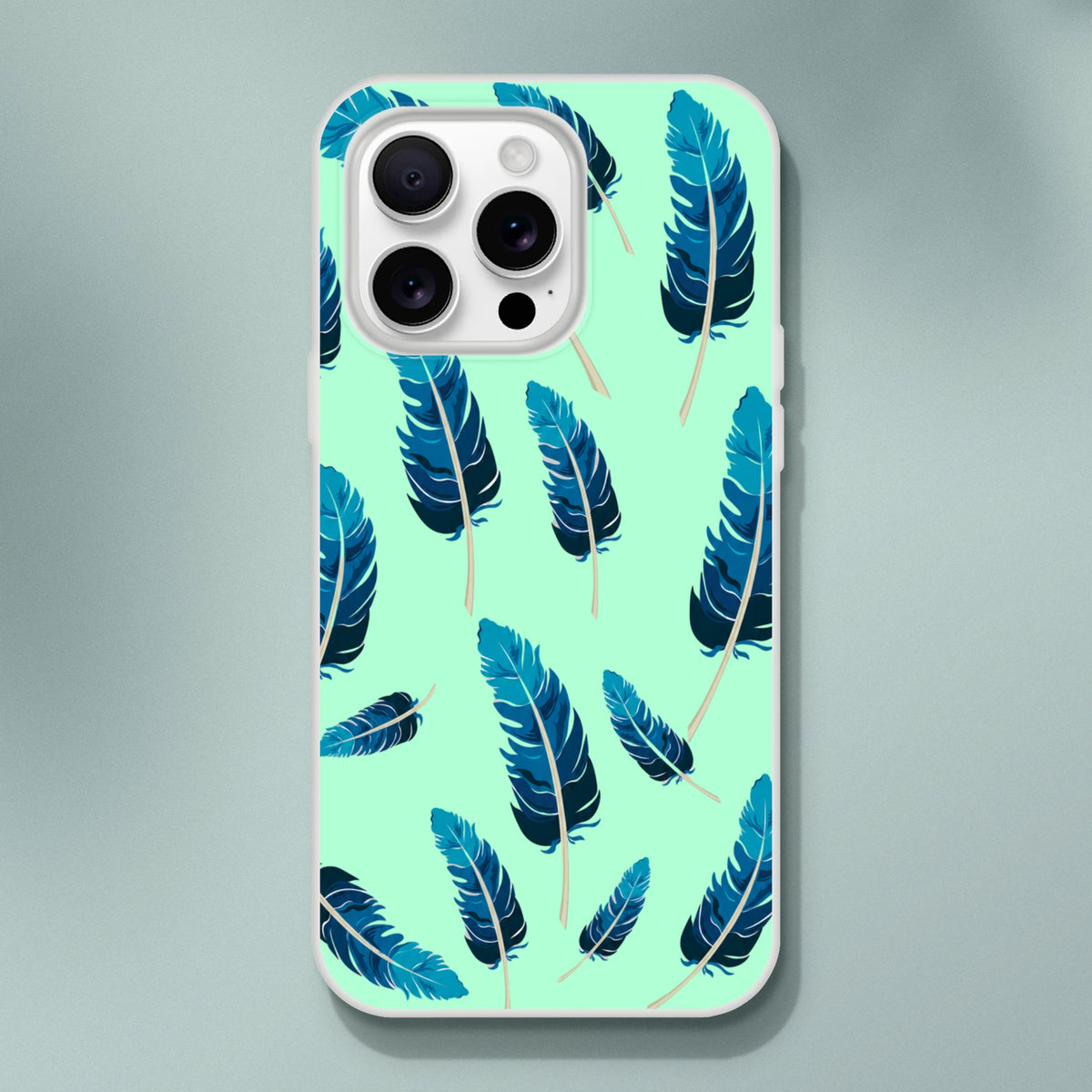 Mint-green iPhone case with blue feather motif, matte finish, lightweight low-profile shell for iPhone 13–16.