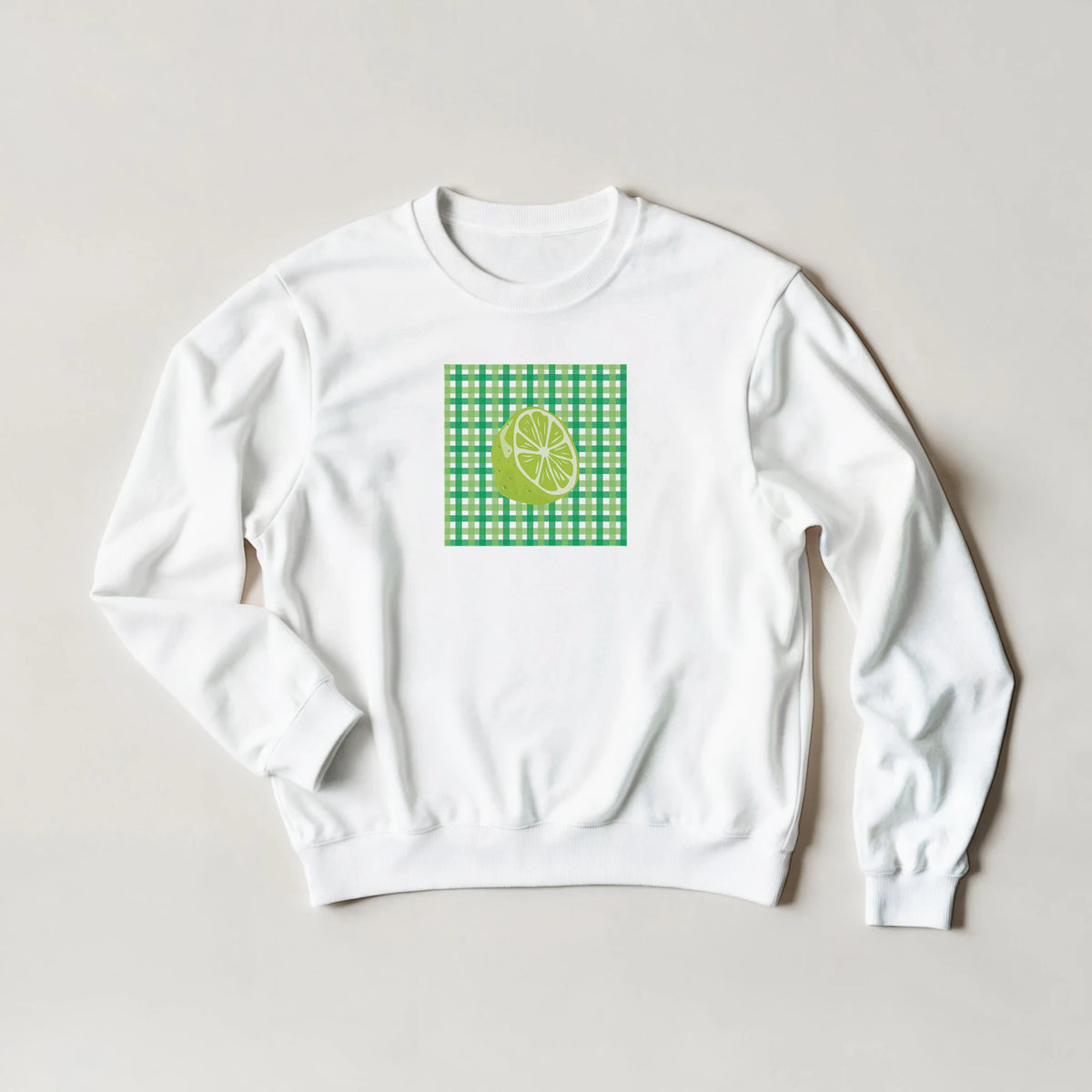 White women's sweatshirt featuring a lime graphic on a green gingham patch.