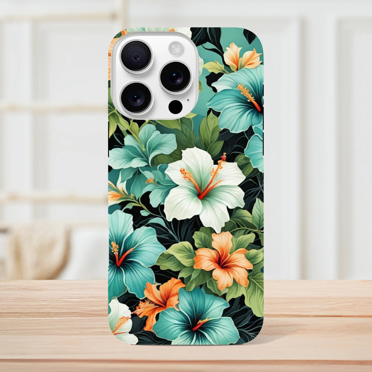 Hibiscus tropical floral iPhone case featuring teal, white, and orange flowers on a dark background with tough shock-absorbing protection.