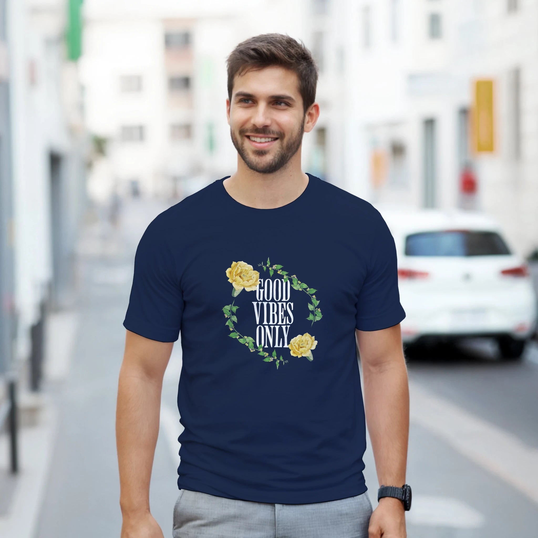 Man wearing navy Good Vibes Only graphic tee with a yellow rose floral wreath design.