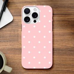 Pastel pink and white polka dot tough iPhone case providing shock-absorbing protection with a cute dual-layer frame.