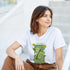 Woman wearing white Lemons graphic T-shirt with lemon can print, outdoors.