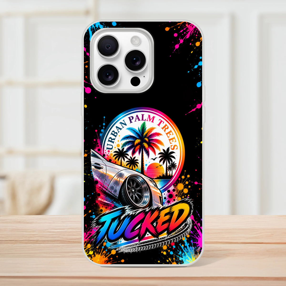 Tucked Stance car culture iPhone case featuring lowered silver car, colorful palm trees, and Urban Palm Trees sunset art.