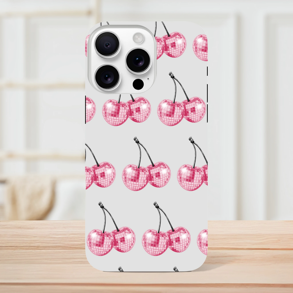 Glitter ball cherries pattern on light-gray iPhone case with dual-layer wraparound protection.
