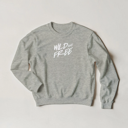 Gray sweatshirt with white "WILD AND FREE" lettering on back, cozy women’s streetwear.