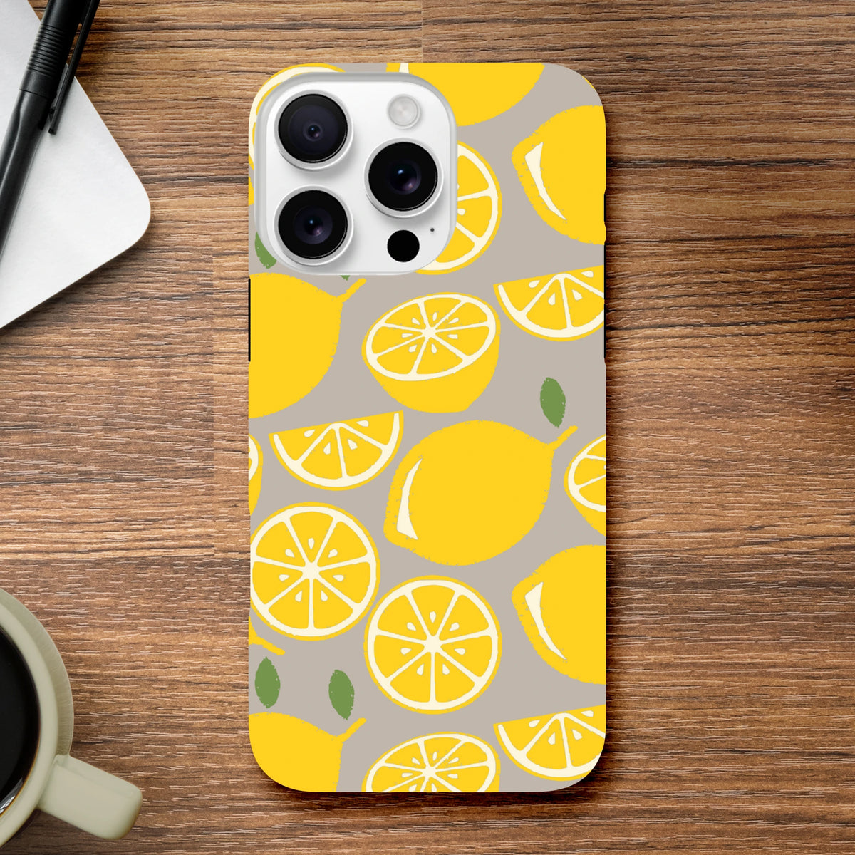 Yellow lemon pattern tough iPhone case with citrus slices on grey background. Durable drop guard cover for city life and street style.