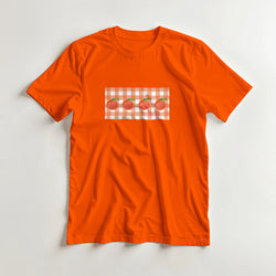 Orange women's T-shirt featuring a peach graphic on a gingham patch.