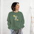Smiling woman wearing a green Mental Health jumper with a Good Vibes Only floral wreath graphic.