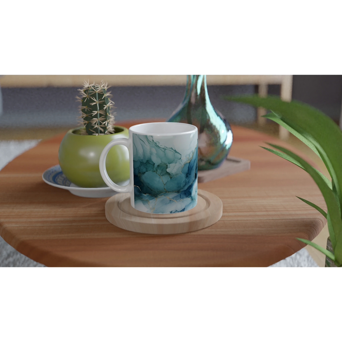 Blue Marble Mug with Ocean Abstract glaze, ceramic coffee cup on a wooden table beside a cactus and turquoise vase.