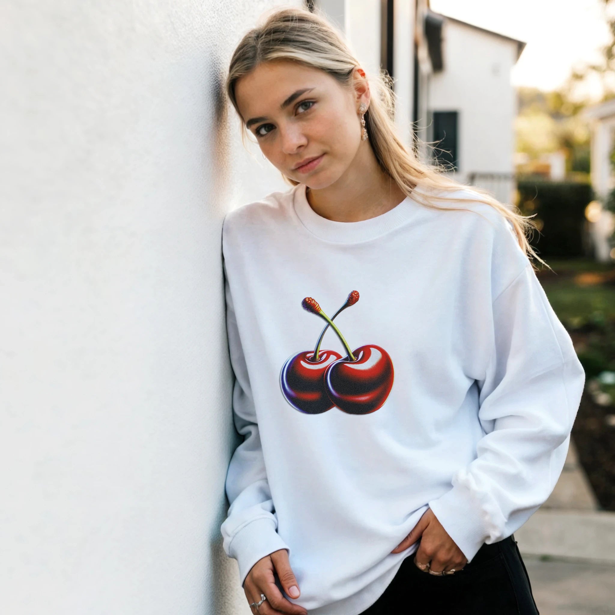 Woman wearing white cotton-blend Cherries Jumper graphic sweatshirt with red cherry print.