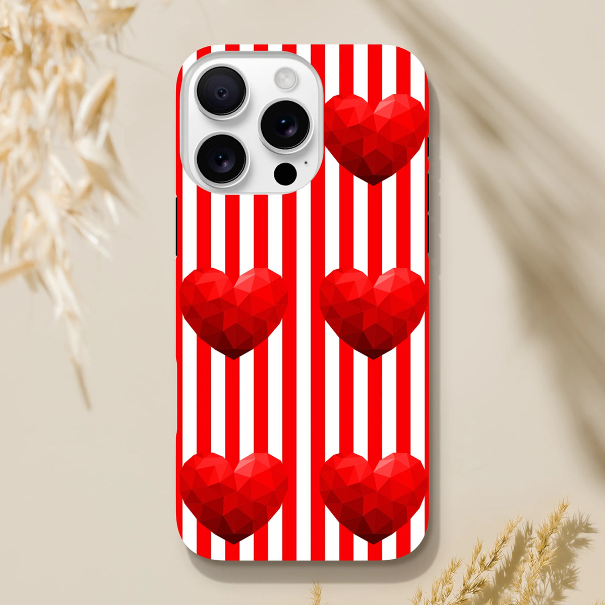 Red and white vertical striped iPhone case featuring retro low-poly red heart designs for impact resistant街头wear protection.