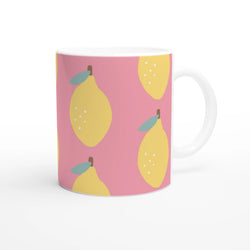 Pink lemon-pattern ceramic mug with yellow lemons and teal leaves, white handle.