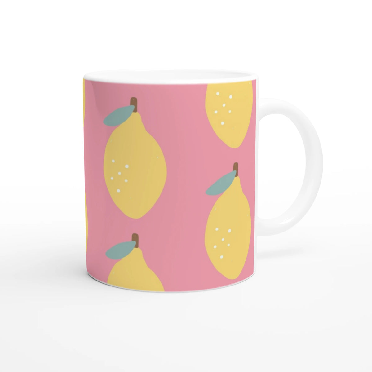 Pink lemon-pattern ceramic mug with yellow lemons and teal leaves, white handle.