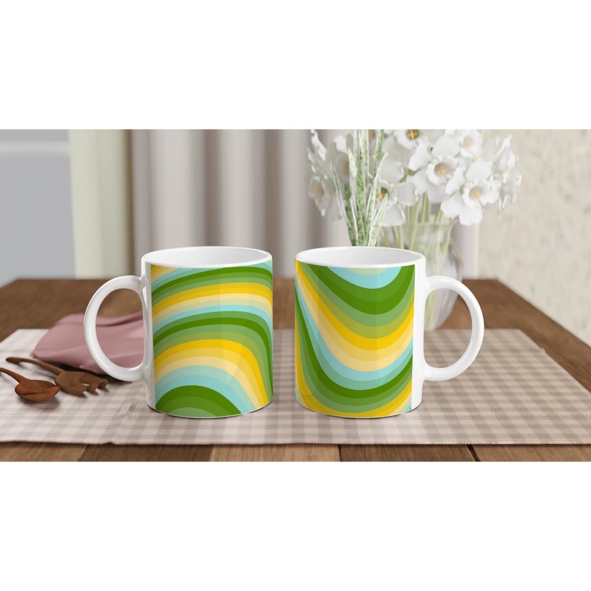 Two retro green-yellow wave mugs with rainbow swirl patterns on a wooden table, white flowers in background.