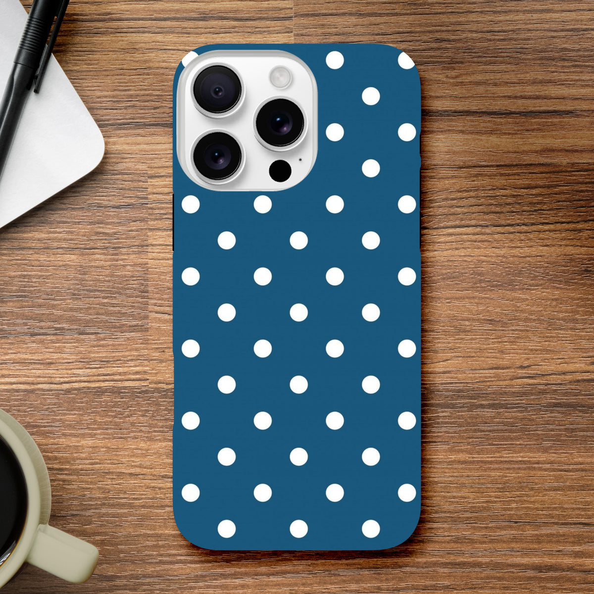 Navy blue and white polka dot tough iPhone case with shock-absorbing TPU and glossy wraparound design for models 13-16.