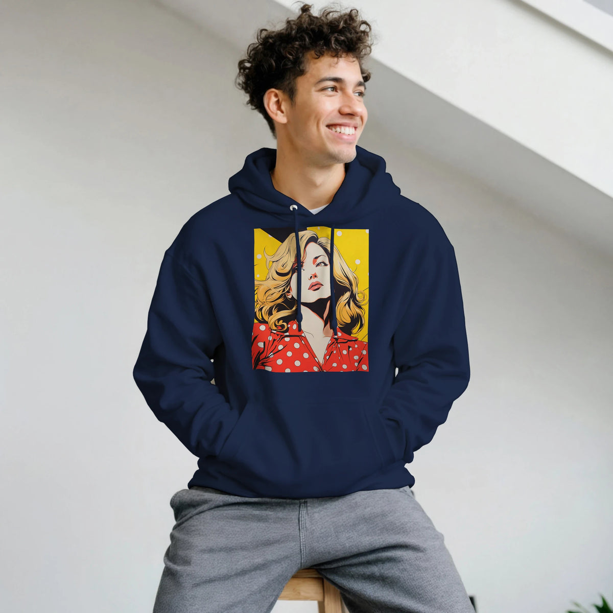 Man wearing navy blue pullover hoodie with retro vintage pop art woman graphic in yellow and red.
