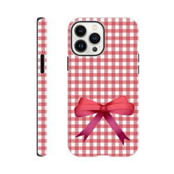 Red gingham iPhone case featuring a pink coquette bow print, designed for tough protection on iOS 13-16 devices.