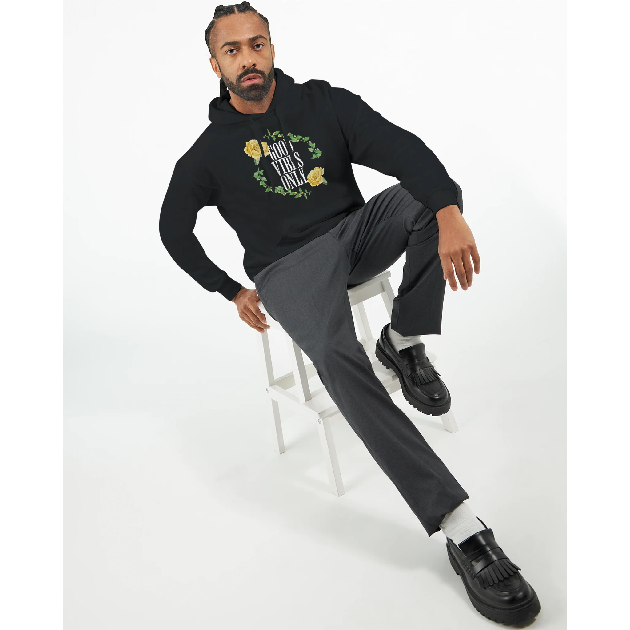 Man wearing black Good Vibes Only graphic hoodie with floral circle design and front pocket.