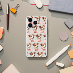 Clear iPhone case for 13-16 with a repeating pattern of cute dogs wearing pink bows.