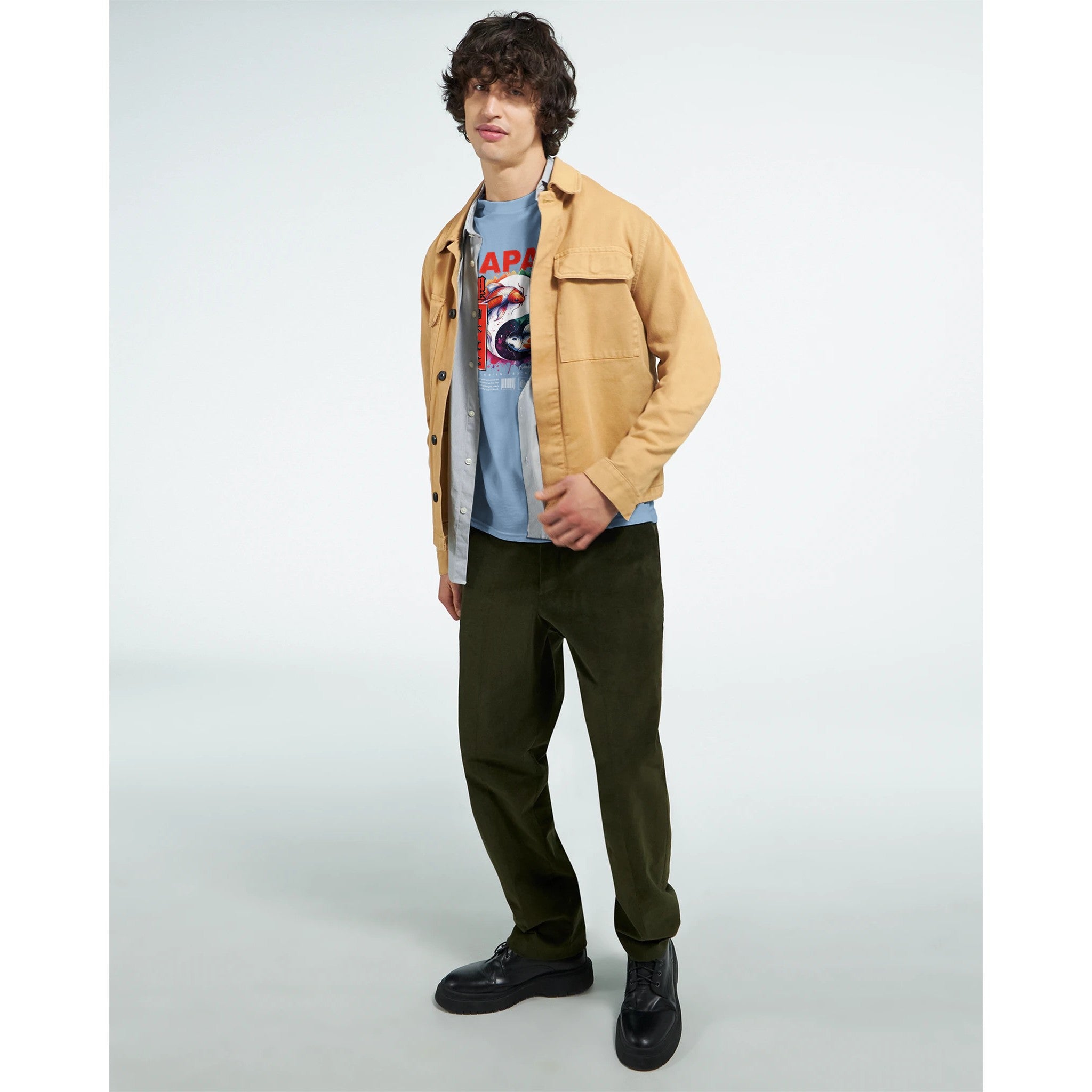 Japanese men's graphic T-shirt in blue, grey, and black; soft cotton blend worn with tan jacket and olive pants.