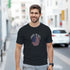 Man wearing black Made in USA graphic T-shirt with circular American flag design.
