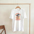 White women's cotton-blend tee with a palm trees graphic and sunburst summer design.
