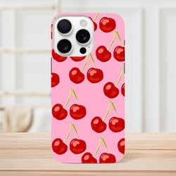 Pink tough iPhone case featuring a cute red cherry pattern on a vibrant pink background, designed for street-ready style.
