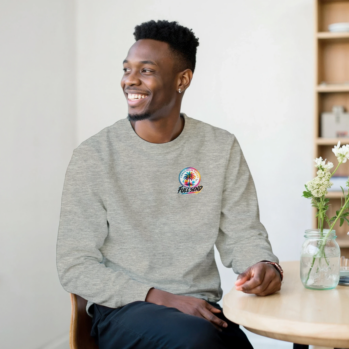 Man wearing heather grey sweatshirt with colorful Urban Palm Trees Full Send logo, blending car culture style with urban fashion.