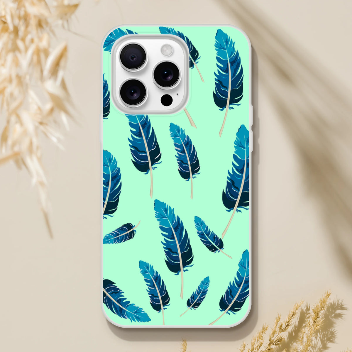Mint-green iPhone case with blue feather motif for iPhone 13–16; matte finish, slim, lightweight shell.