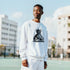 Man in white cotton-blend DJ Club graphic sweatshirt outdoors, chest Statue of Liberty DJ console design.