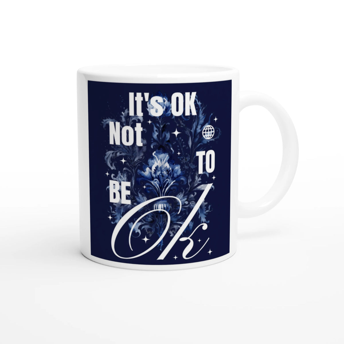 Glossy white ceramic mug featuring navy panel with It's OK Not To Be OK and floral design.
