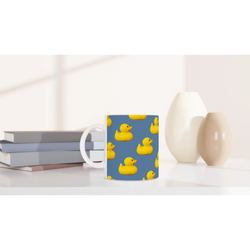 Blue aesthetic rubber duck ceramic mug with yellow duck prints, a cute coffee cup.