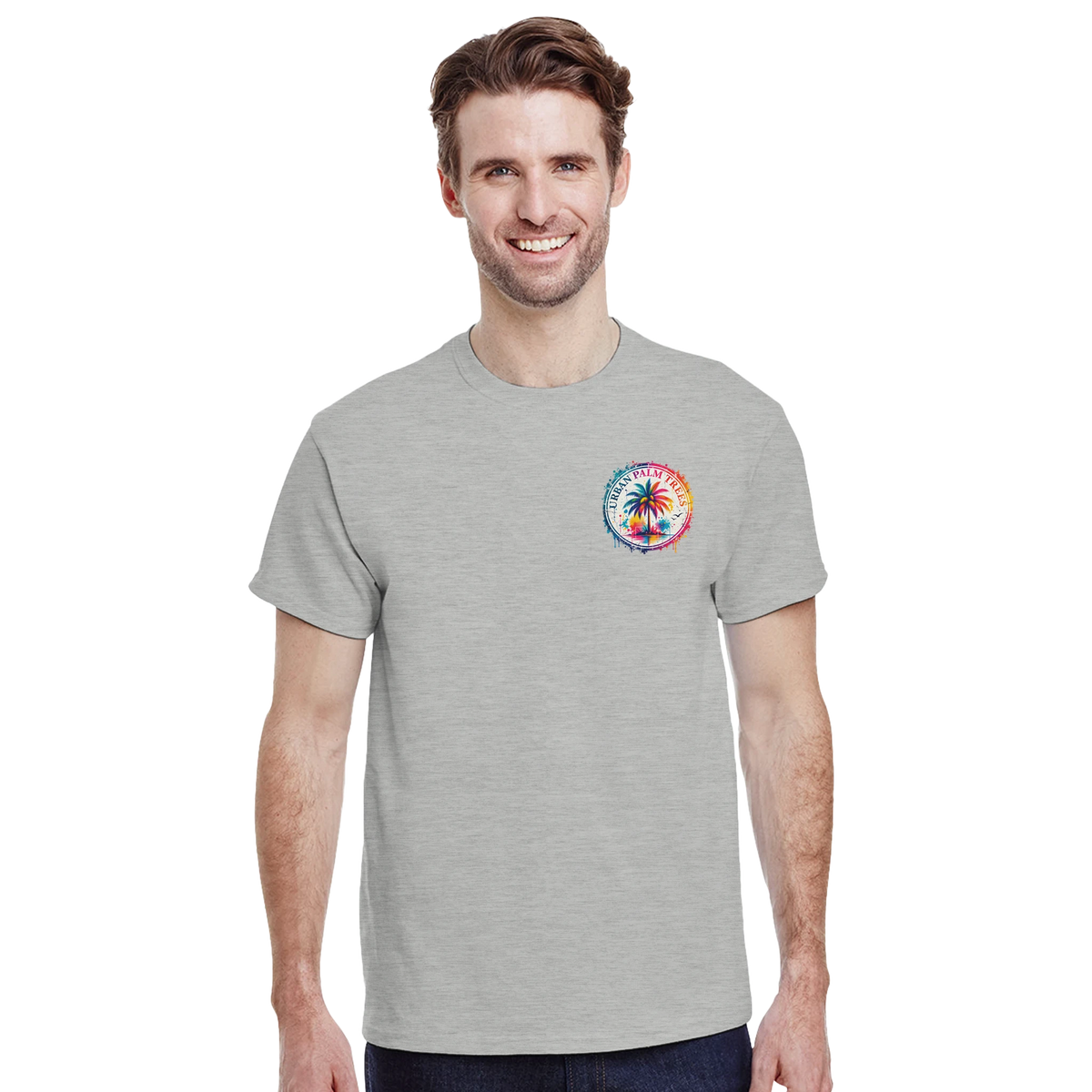 Man wearing a grey t-shirt with a small colorful circular urban palm tree graphic on the left chest.