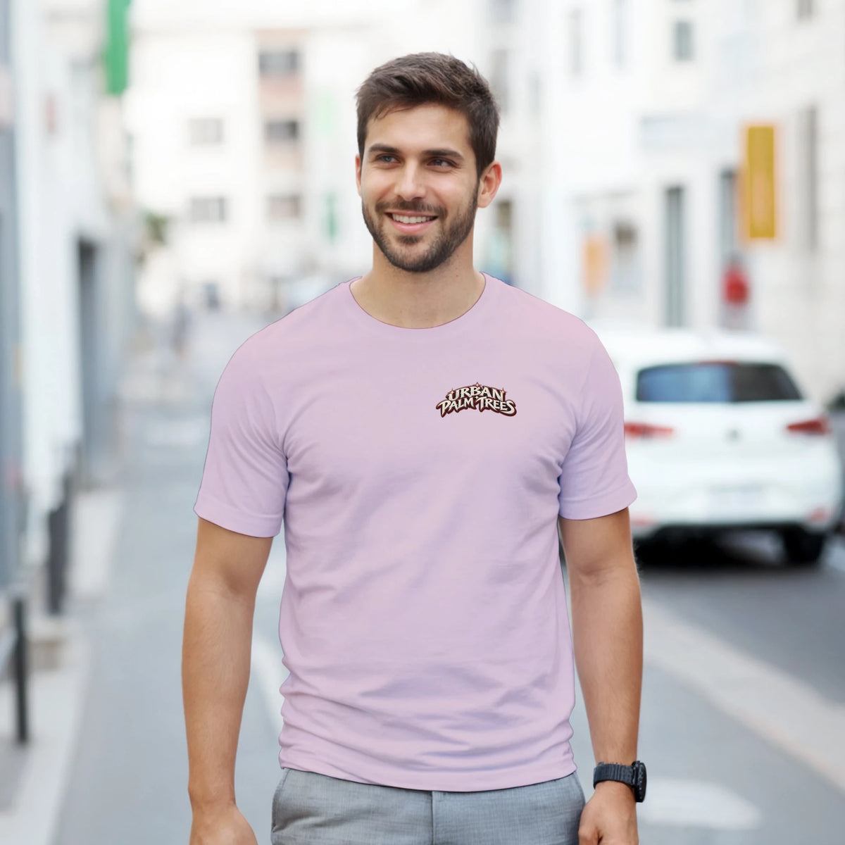 Man wearing light purple crew-neck t-shirt featuring Urban Palm Trees logo on the chest for retro streetwear style.
