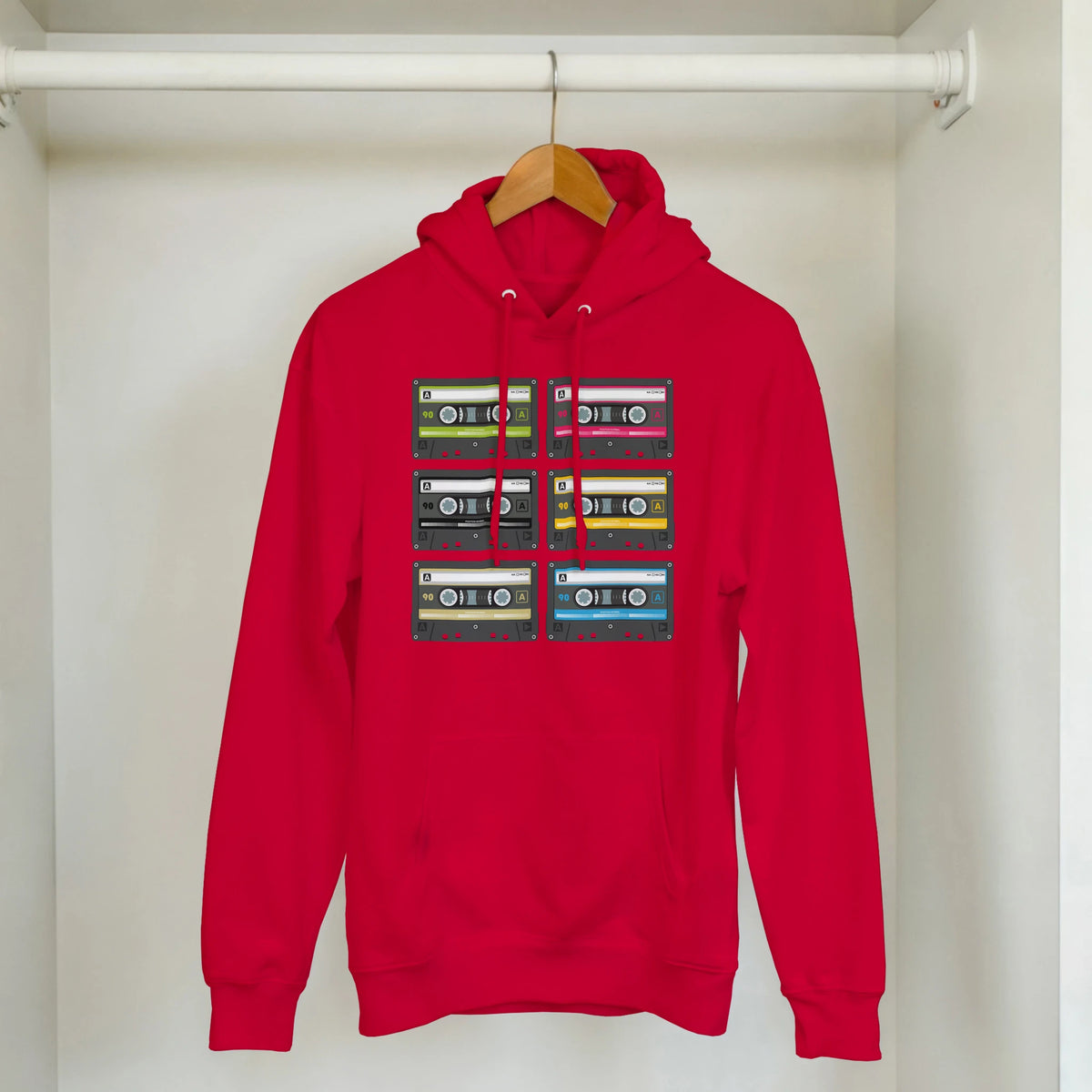 Red Retro Cassette Tape Hoodie on a hanger with stacked cassette prints, vintage 90s graphic pullover.
