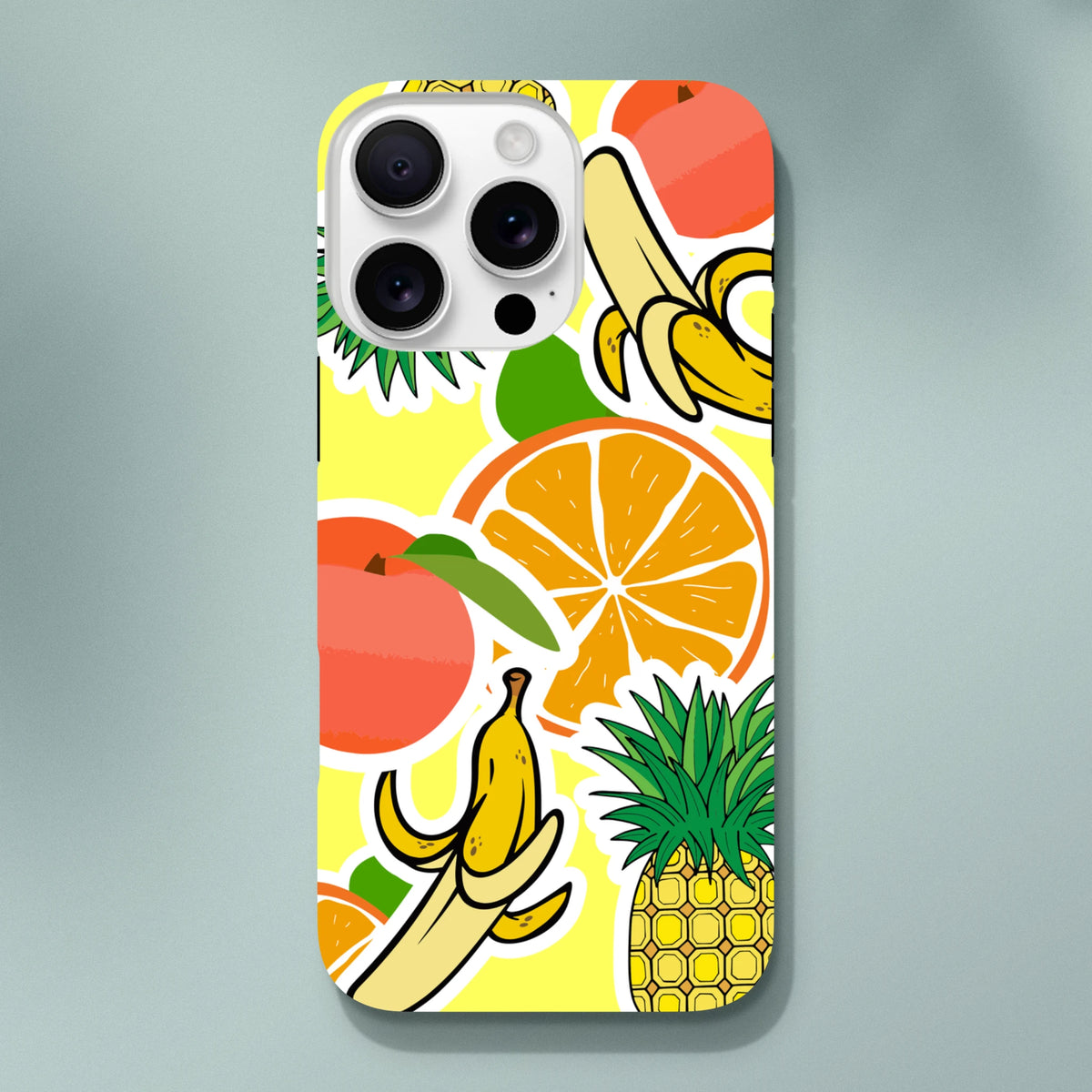 Yellow iPhone case with bold sticker-style orange, banana, and pineapple graphics on a vibrant background.