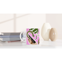 Pink western ceramic coffee mug featuring cowboy boots, cactus, and horseshoe illustration on a vibrant pink background.