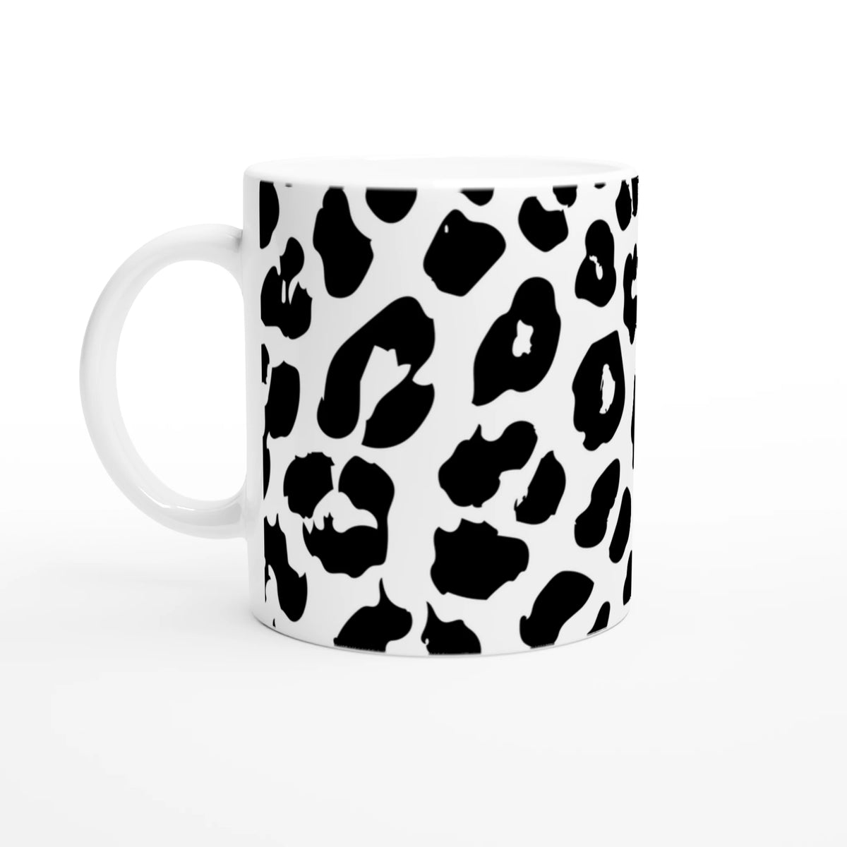 Retro Snow Leopard Mug: white ceramic with bold black spots for an animal aesthetic coffee cup.