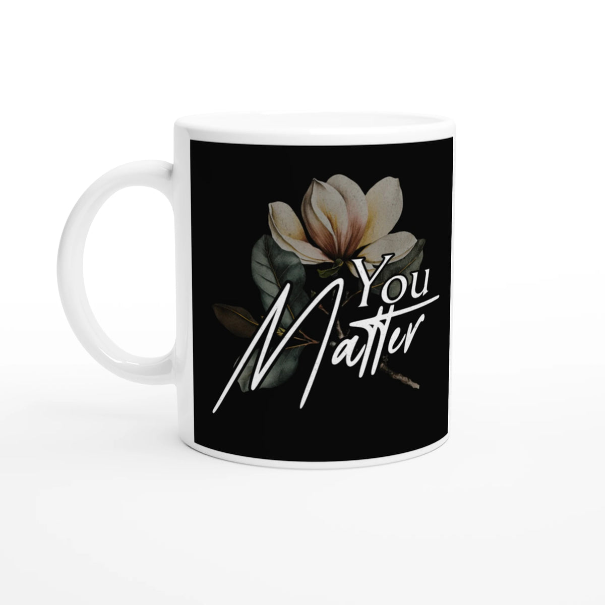 White ceramic mug with a black label featuring a magnolia and the "You Matter" slogan.