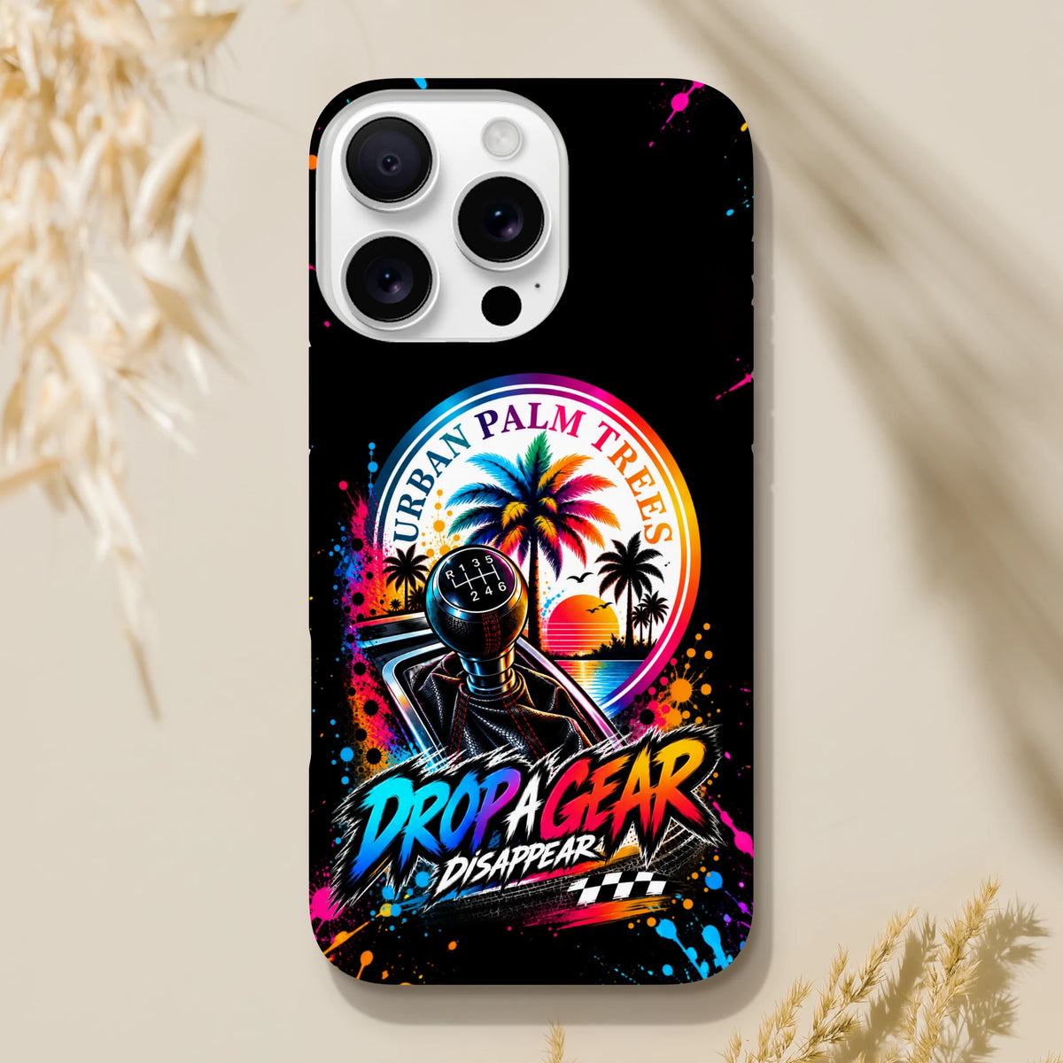 Black iPhone case featuring a colorful manual gear shifter, palm trees, and "Drop A Gear" graffiti text with paint splatter accents.