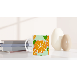 Cute orange mug with citrus slice design for coffee or tea.