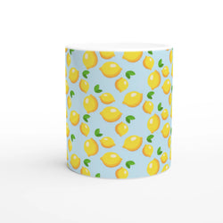 Cute mini lemon-pattern ceramic mug on a blue background, a charming citrus coffee cup for tea or coffee.