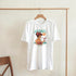 White women's graphic T-shirt with a soft cotton blend, Aloha tropical cocktail illustration and teal text.