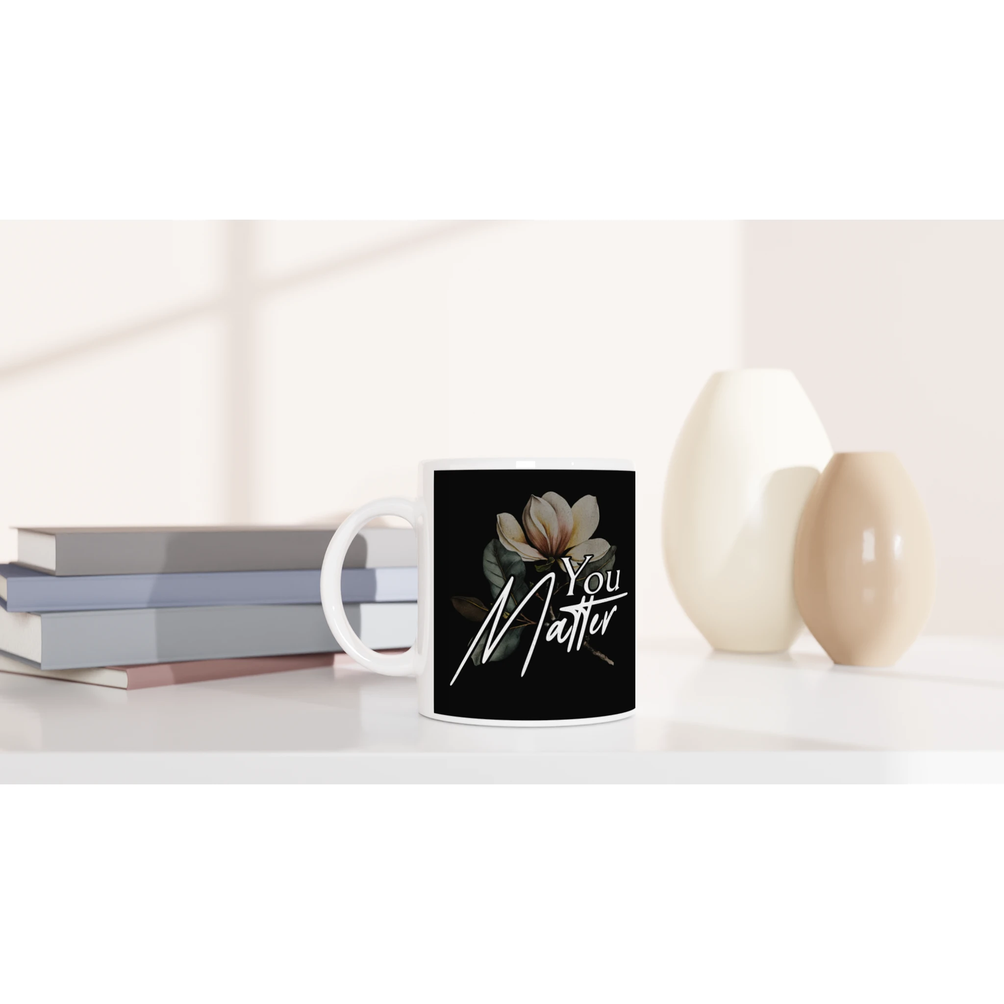 White ceramic mug featuring a black label with the You Matter slogan and a floral illustration.