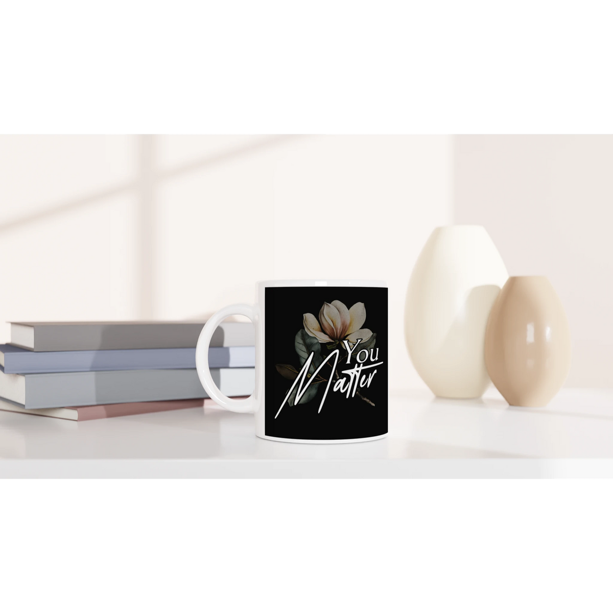 White ceramic mug featuring a black label with the You Matter slogan and a floral illustration.