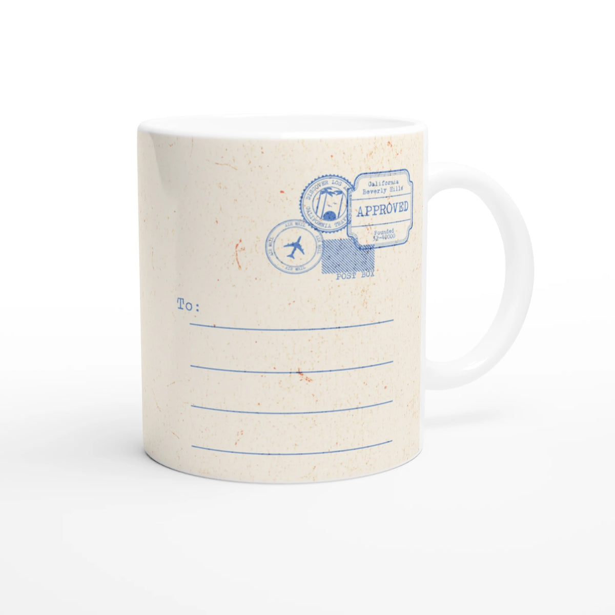 Retro postcard mug with blue stamp design on speckled cream ceramic.
